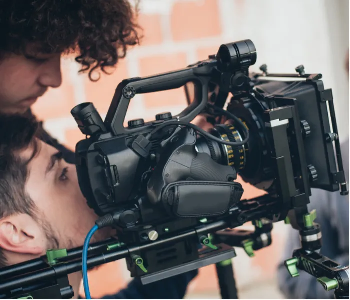 Two men working behind the camera