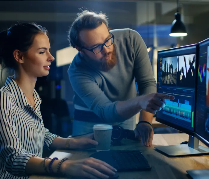 Man and woman looking at computer screens