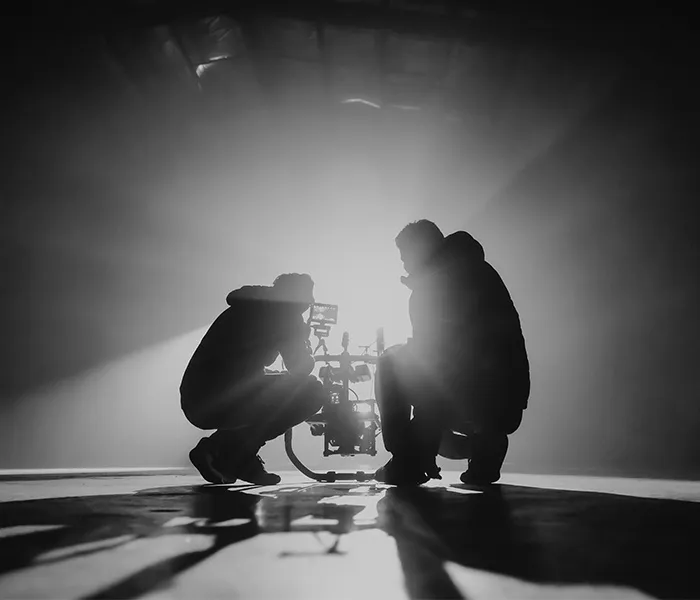 Silhouette of a cameraman kneeling down