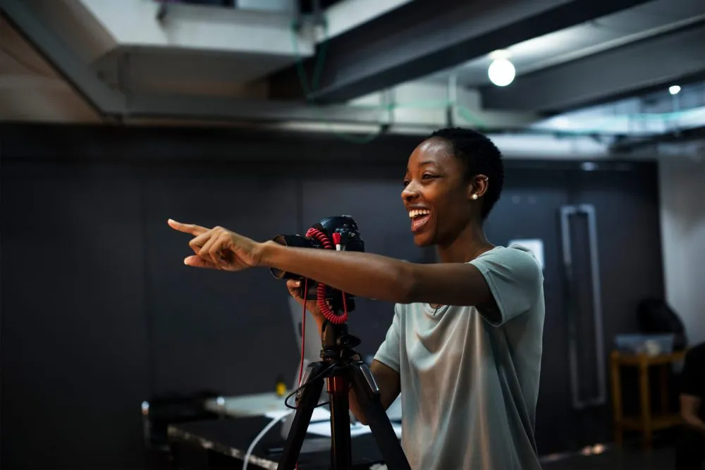 Woman behind the camera pointing